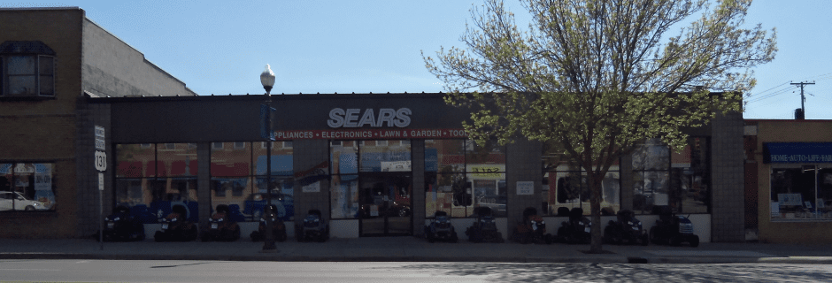 Sears store with parked cars on the street