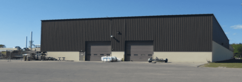 a large warehouse with a large parking lot